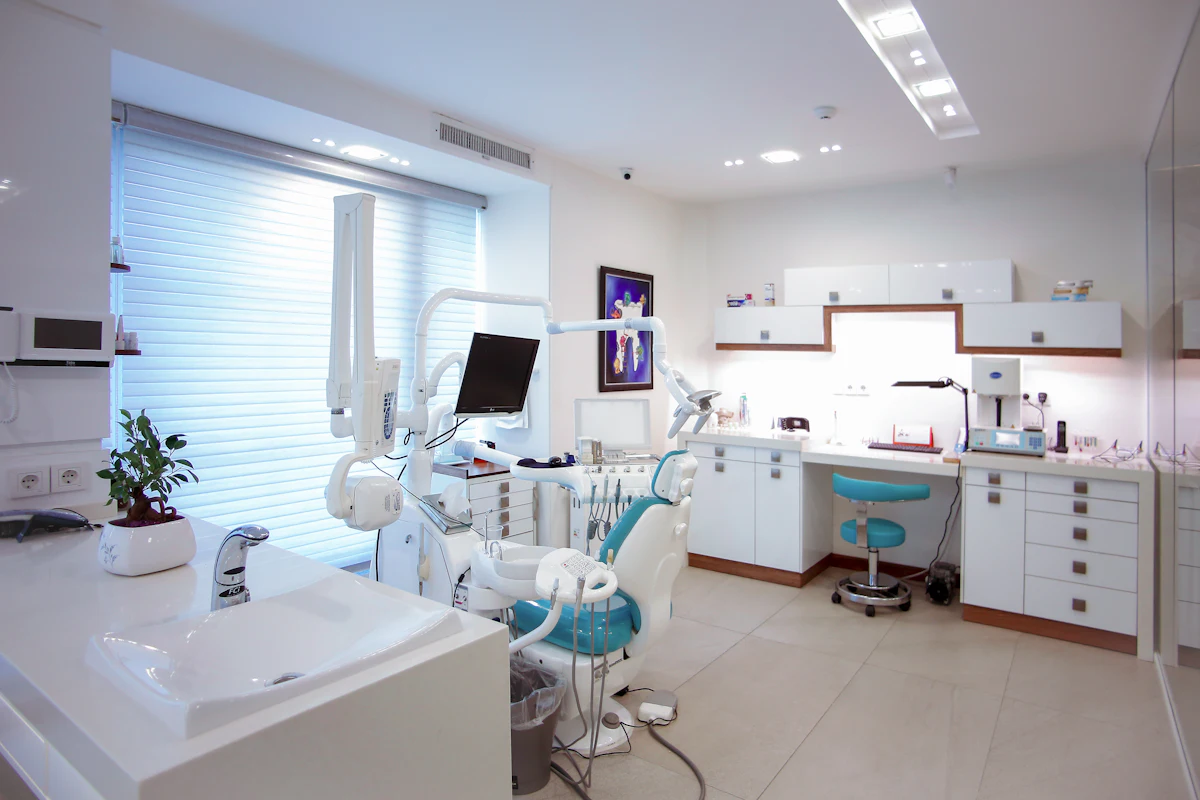 A bright treatment room at Origin Dental with a dental chair beside the window