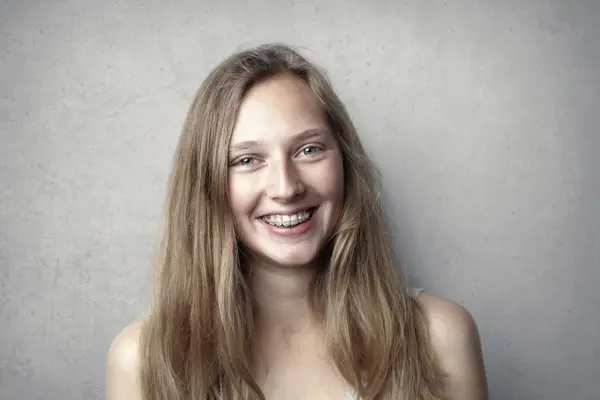 A smiling young woman wearing braces
